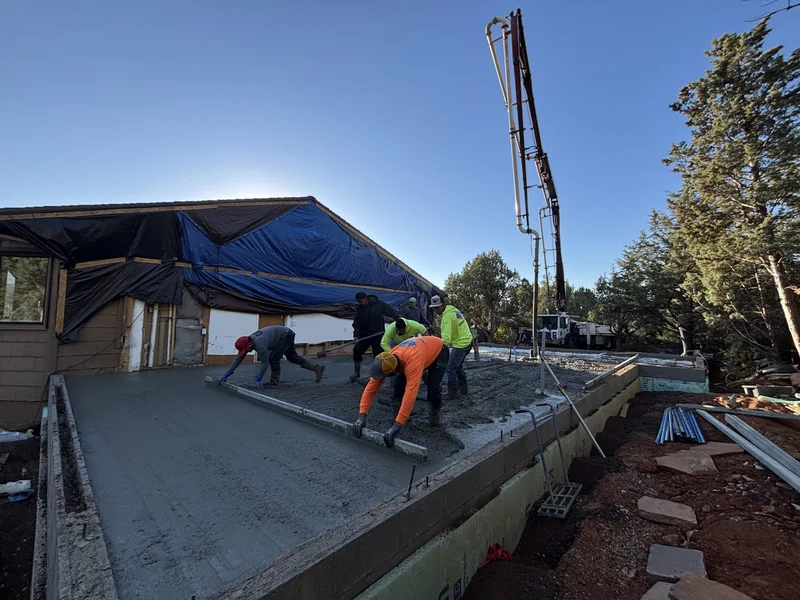 Crew pouring the concrete slab for the addition