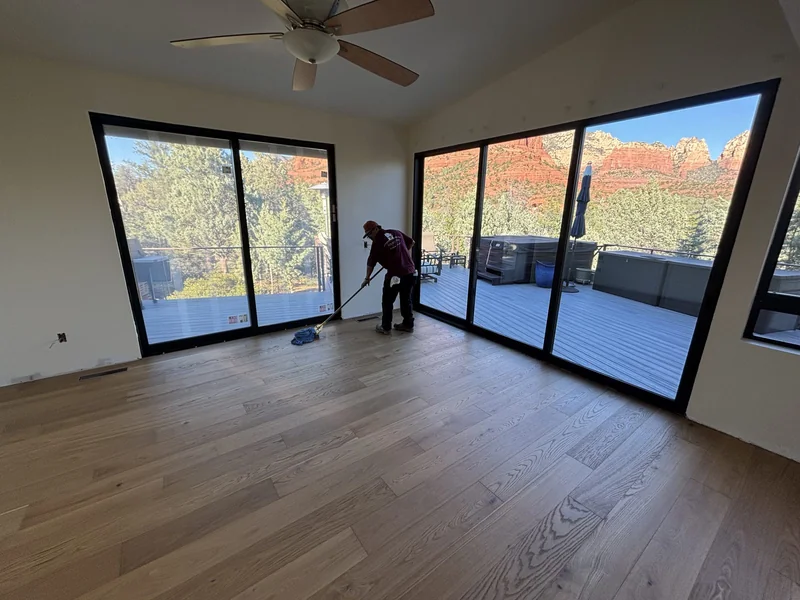 Finished interior with the floor to ceiling glass wall and red rock views