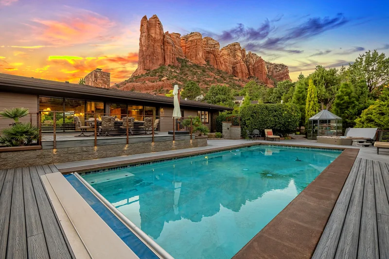Pool and outdoor living space at sunset with red rock backdrop