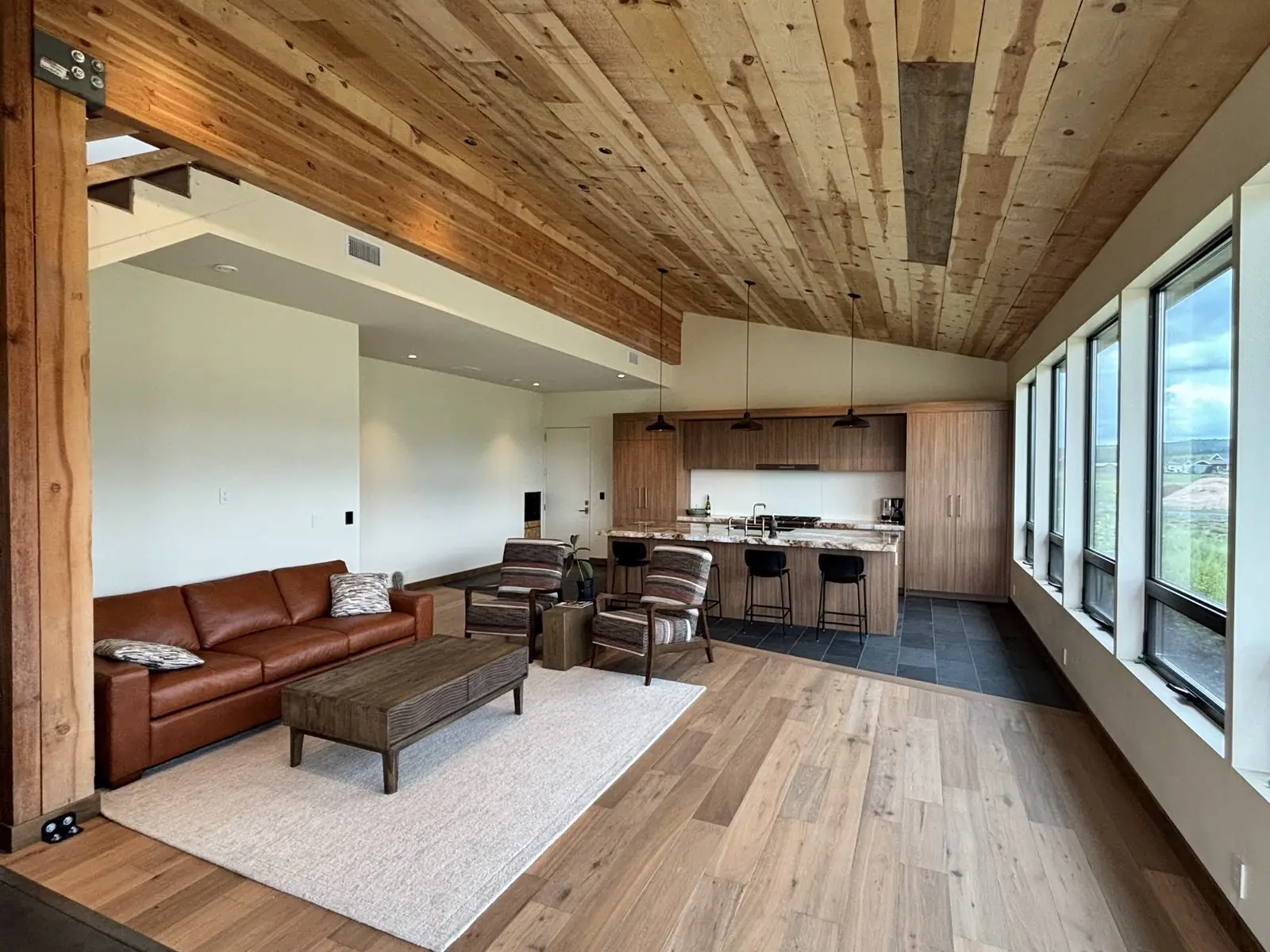 Kelsey Springs kitchen open to the great room with vaulted wood ceiling
