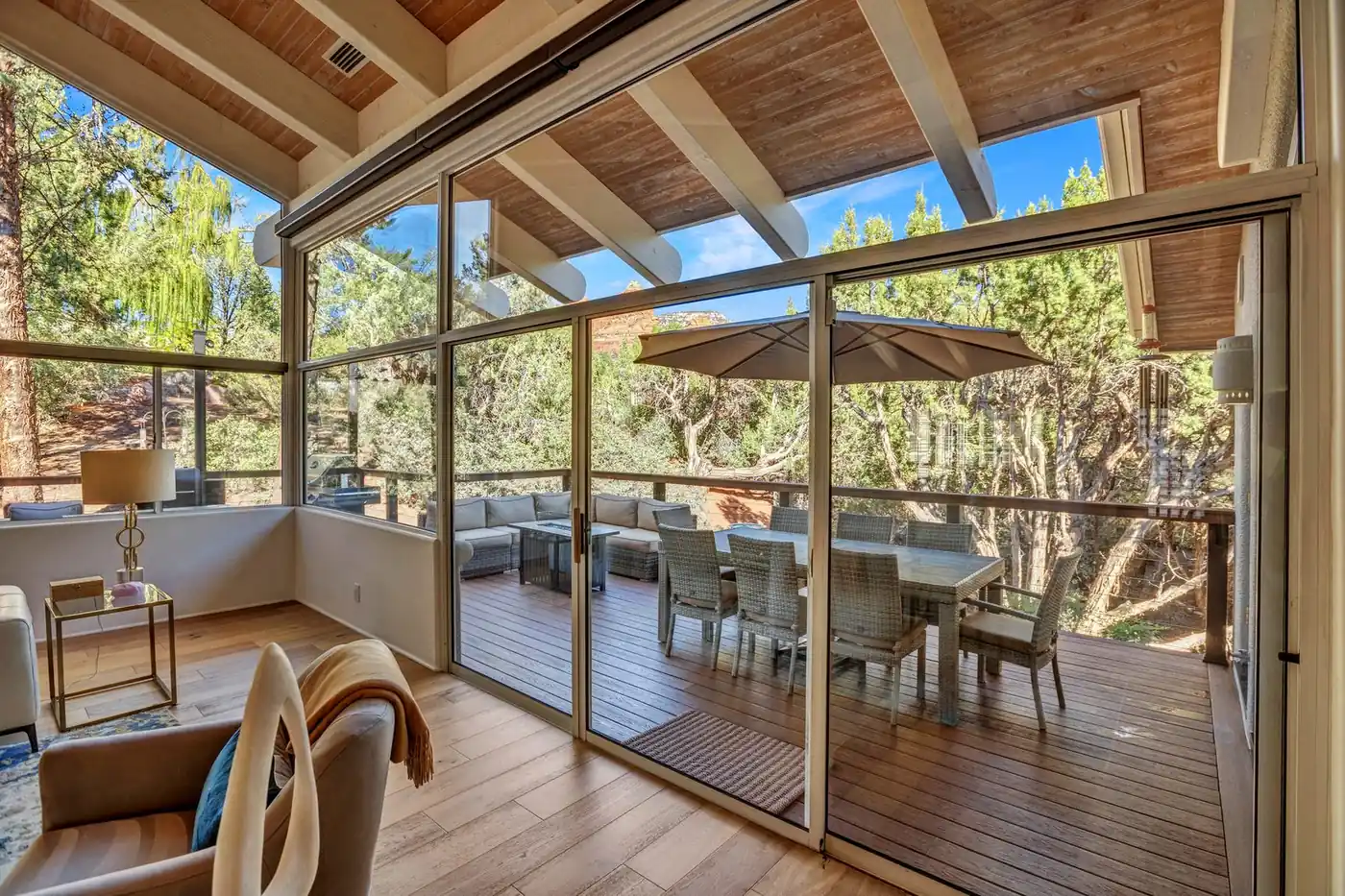 Covered deck with beamed roof structure and outdoor dining set